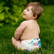 Load image into Gallery viewer, Lava Rumparooz One Size Cloth Diaper on a baby sitting outside in the grass
